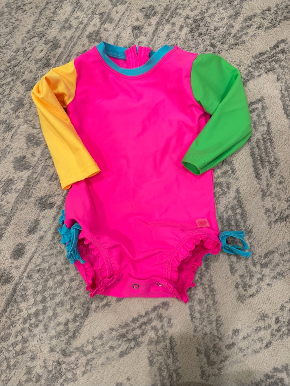 Ruffle Butts Neon Pink One-Piece Swimsuit with Yellow and Green Sleeves